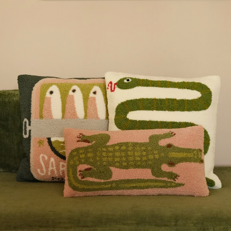 Decorative pillows with animal designs on a couch.